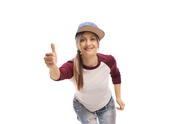 Trendy young girl making a thumb up gesture isolated on white background - Fotó, kép