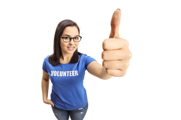 Young woman volunteer showing thumbs up isolated on white background - Photo, image