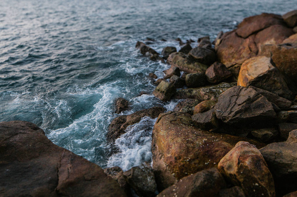 dalgalar ve köpük ile taşlı plaj sunset - Fotoğraf, Görsel