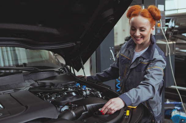 Female mechanic working at car service station - Photo, Image