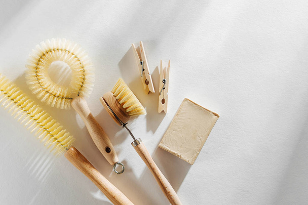 Eco friendly natural cleaning tools and products, bamboo dish brushes and soap on white background. Zero waste concept. Plastic free. Flat lay, top view - Photo, image