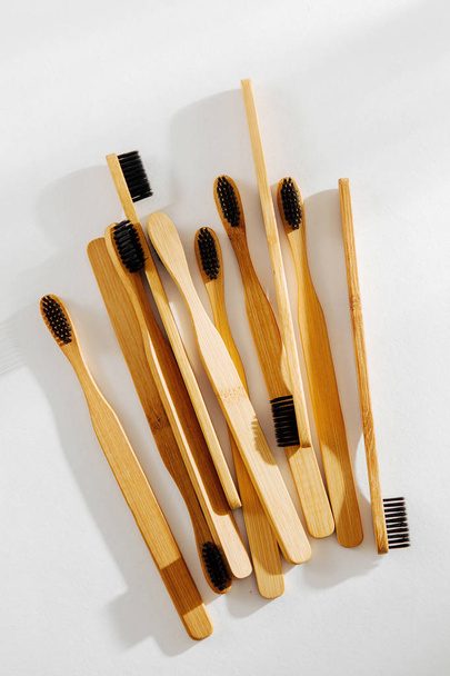 Eco friendly bamboo toothbrushes with black bristle, bathroom essentials on white background. Zero waste, plastic free concept.  - 写真・画像