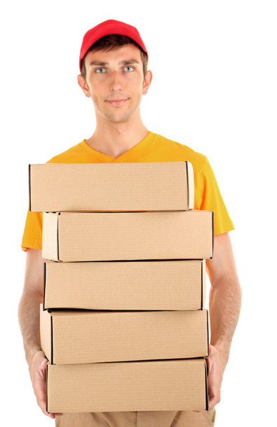 Young delivery man holding parcels, isolated on white - Fotoğraf, Görsel
