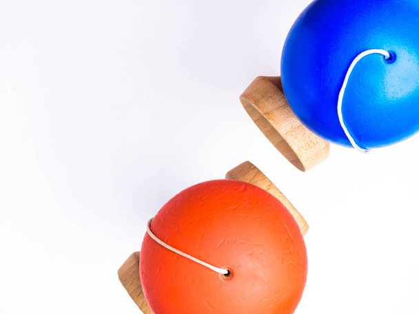 orange und blau farbenfrohe kendama japanische Spielzeuge, isoliert auf weiß, Wettbewerbskonzept - Foto, Bild