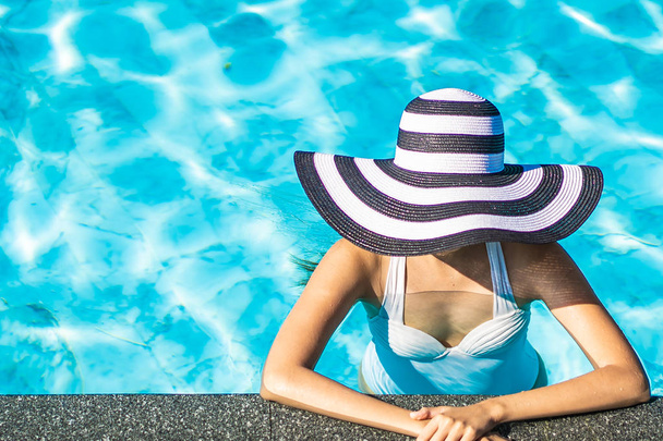 Belle jeune femme asiatique avec chapeau dans la piscine pour Voyage
 - Photo, image