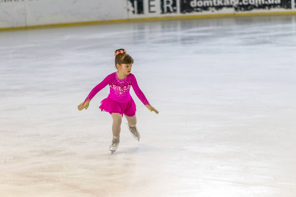 ODESSA, UKRAINE -11 Apr 2019: Young children figure skating on ice arena of stadium. Little girls learn to skate. School of figure skating. Young figure skaters train at indoor rink. Young sport girls - Photo, Image