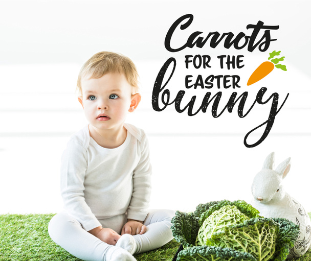 cute baby sitting near savoy cabbage and decorative rabbit with carrots for the Easter bunny illustration on white background - Photo, Image