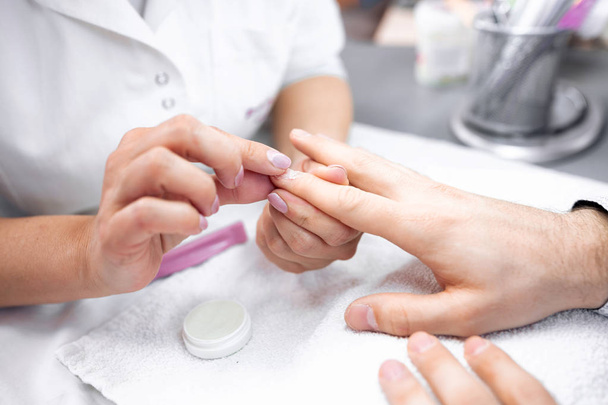Nail grooming on the man hands during manicure treatment - Zdjęcie, obraz