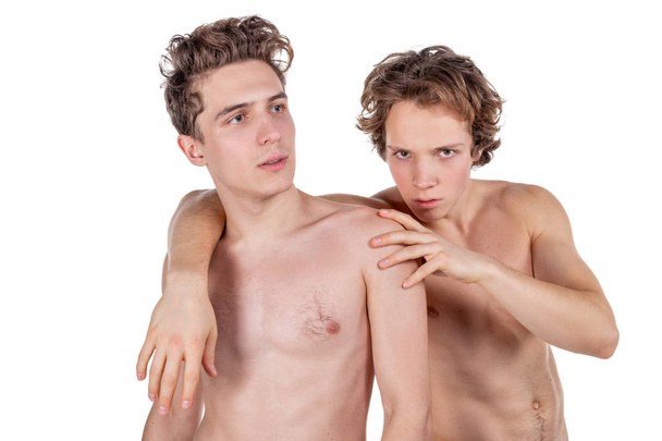Two young sexy guys hugs on a white background. Love, passion and relationships - Fotó, kép