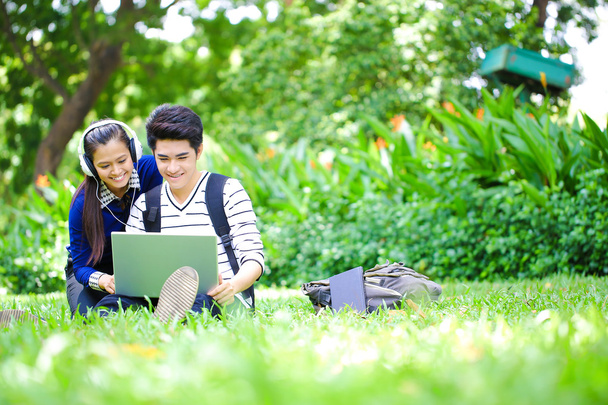 Young Asian students with computer and smile in outdoor - Fotoğraf, Görsel