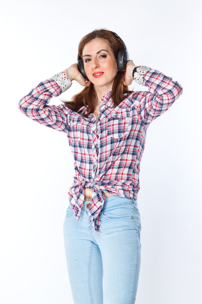 Woman listening to music on headphones - Photo, Image