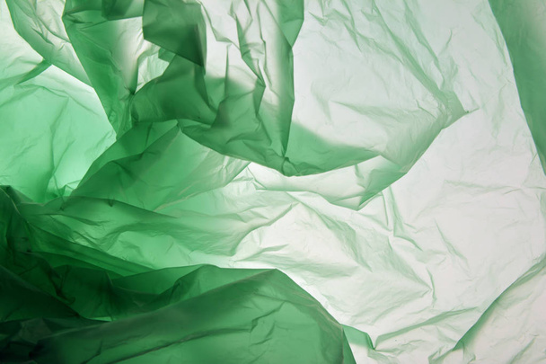 Plastic bag concept. Polyethylene may use as background. Plastic of different shades of green. Background for design. Template for card, poster, banner design. Colourful texture. - Foto, immagini