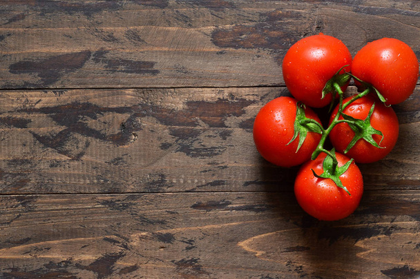 Bunch of fresh tomatoes on a concrete background.  - Zdjęcie, obraz