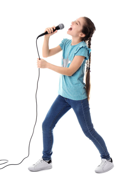 Cute girl singing in microphone on white background - Фото, изображение