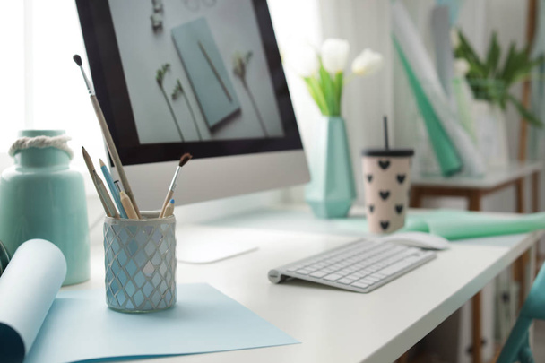 Stylish workplace with modern computer on desk. Focus on pencil holder - Photo, Image