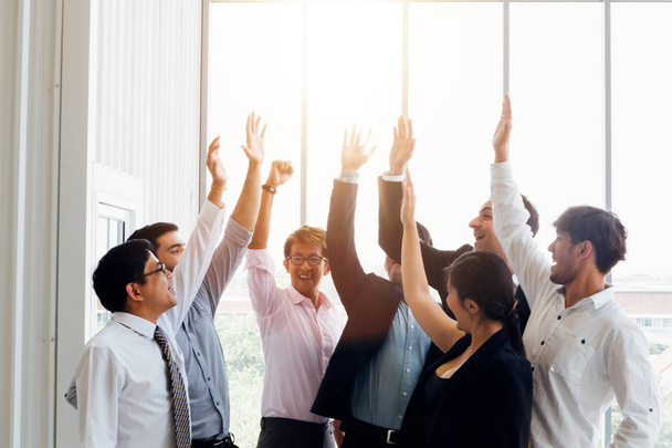 Cheerful diverse business people holding arms raised - Photo, Image