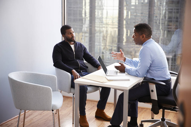 Man Meeting With Male Financial Advisor Relationship Counsellor In Office - Photo, image