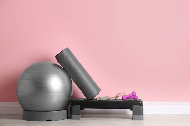 Set of fitness inventory on floor near color wall. Space for text - Fotografie, Obrázek
