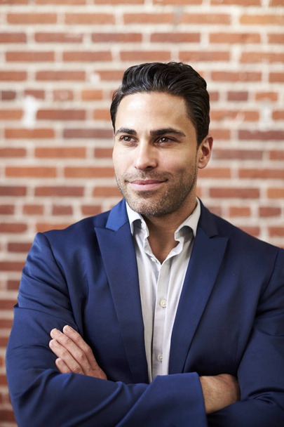 Smiling Mature Businessman Standing Against Brick Wall In Modern Office - Photo, Image