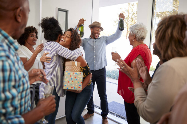Millennial black couple arriving at a family party with gifts and champagne - Fotografie, Obrázek