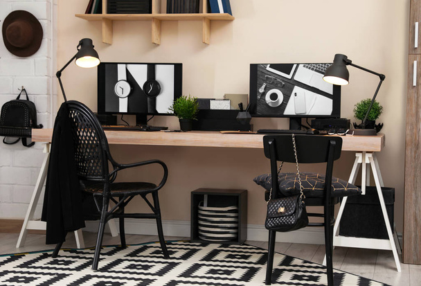Stylish workplace interior with computers on table - Zdjęcie, obraz