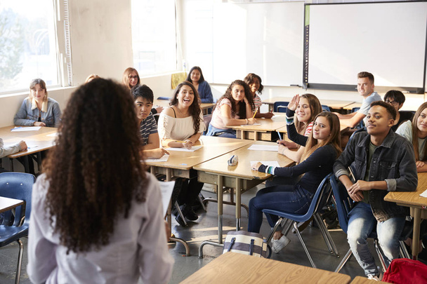 Rear View Of Female High School Teacher Standing At Front Of Class Teaching Lesson - Photo, Image