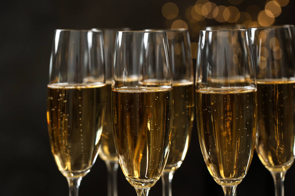 Many glasses of champagne on blurred background, closeup - Photo, Image
