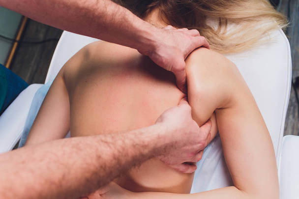 Young beautiful woman having massage in spa salon Physiotherapis. - Фото, зображення