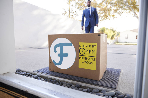 carton package at doorstep, African businessman coming back home  - Fotó, kép