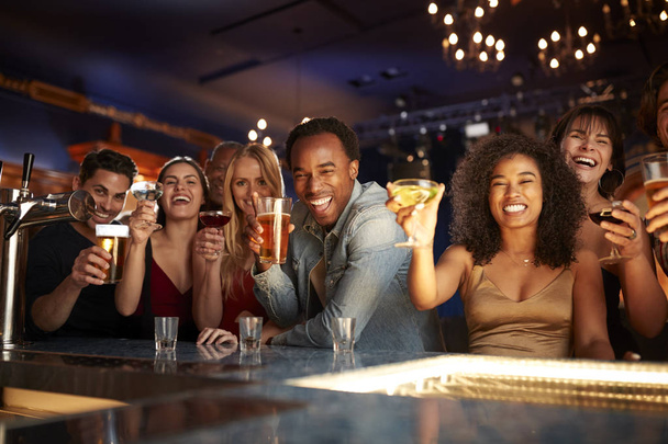 Portrait Of Couples With Friends Drinking In Bar Together - Foto, Imagen