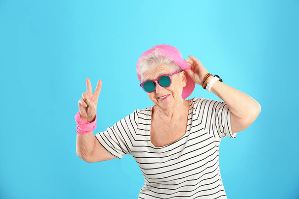 Portrait of cool grandmother on color background - Фото, изображение