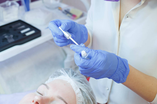 Woman on the procedure for eyelash extensions, eyelashes lamination - Φωτογραφία, εικόνα
