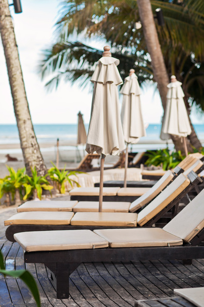 Beach chairs near swimming pool in tropical resort, Thailand. - Foto, immagini