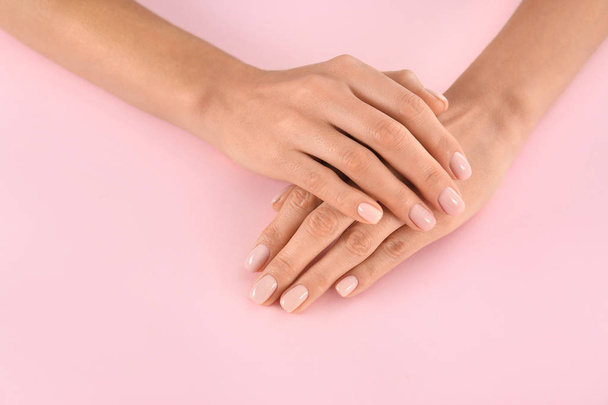Closeup view of woman with beautiful hands on color background. Spa treatment - Fotoğraf, Görsel
