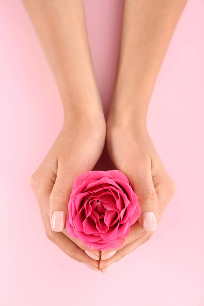 Closeup view of woman with rose on color background. Spa treatment - Φωτογραφία, εικόνα