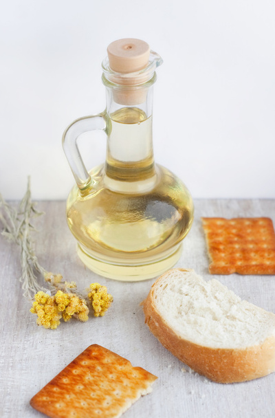 Slunečnicový olej ve skleněné konvici, cookies, krajíc chleba a fl - Fotografie, Obrázek