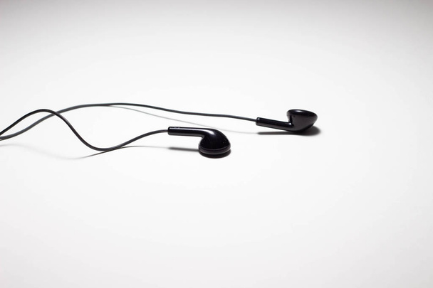 old Black Earphones or Ear Buds on iSolated White Background. - Photo, Image