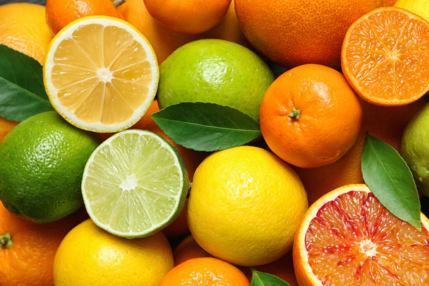 Many different citrus fruits as background, top view - Fotografie, Obrázek