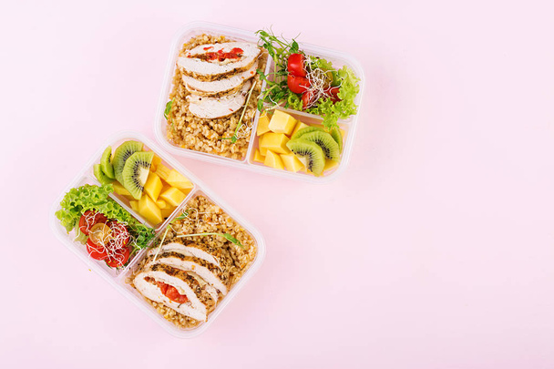 Lunch box  chicken, bulgur, microgreens, tomato  and fruit. Healthy fitness food. Take away. Lunchbox. Top view - Photo, Image