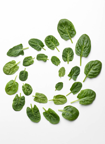 Frame made of spinach leaves on white background, top view. Space for text - Foto, afbeelding