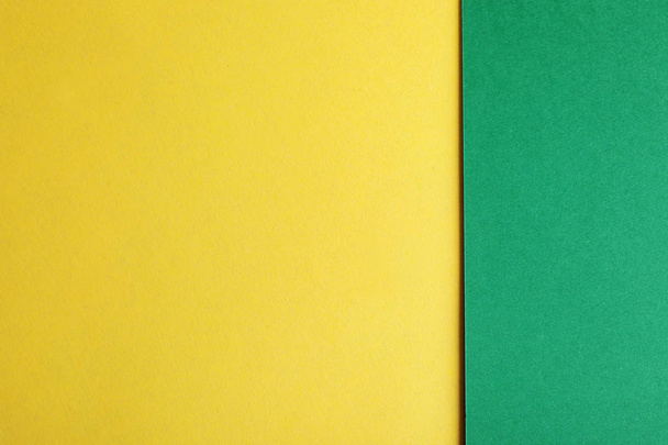 Green and yellow paper sheets as colorful background, top view - Valokuva, kuva