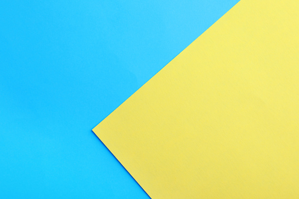 Blue and yellow paper sheets as colorful background, top view - Fotoğraf, Görsel