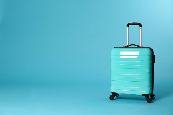 Stylish suitcase on color background. Space for text - Fotó, kép