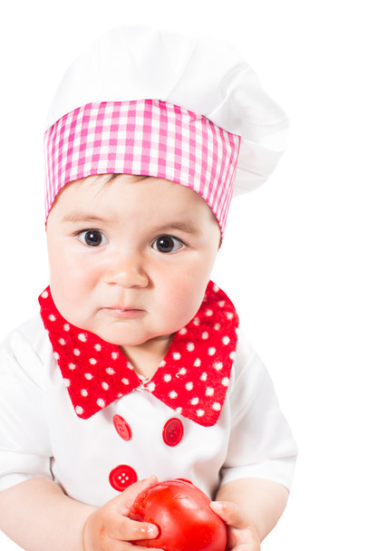 Baby girl wearing a chef hat with tomato . Use it for a child, healthy food concept - Foto, Bild