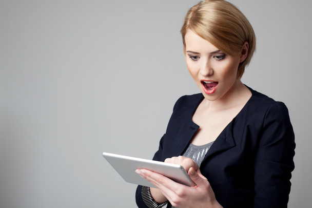 Attractive young woman using digital tablet - 写真・画像