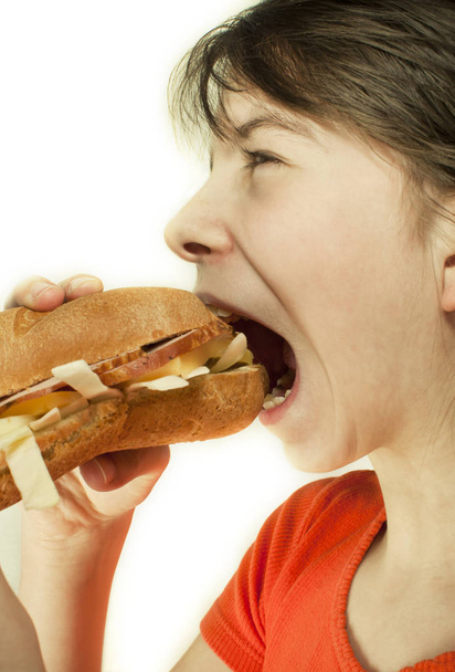 Teen girl eats a huge hamburger - Zdjęcie, obraz