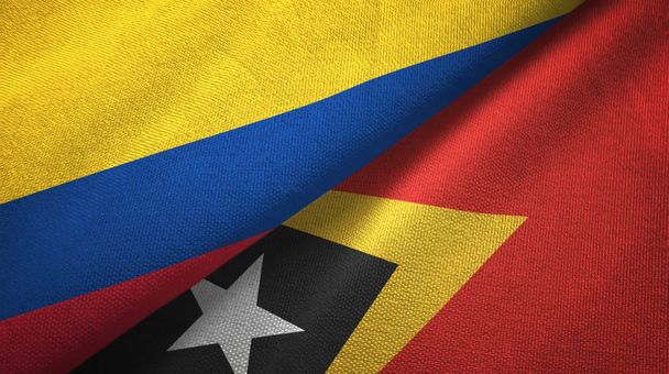 Kolumbia i Timor Wschodni Timoru Wschodniego dwie flagi tkanina tekstylna, tekstura tkaniny - Zdjęcie, obraz
