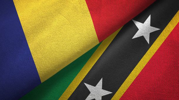 Roemenië en Saint Kitts en Nevis twee vlaggen textiel doek, stof textuur - Foto, afbeelding