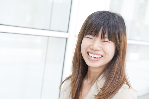 Asian business women smiling with office background - Foto, Imagen