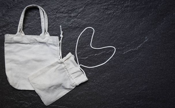 White tote canvas fabric eco bag cloth shopping sack on dark bac - Photo, Image